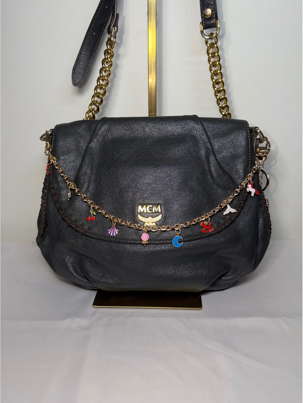 MCM Black Leather Crossbody Bag with Gold Chain and Charm Details